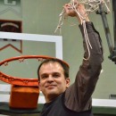 NorthWood boys basketball head coach Aaron Wolfe holds the net after the Panthers beat West Noble 75-61 Saturday night.