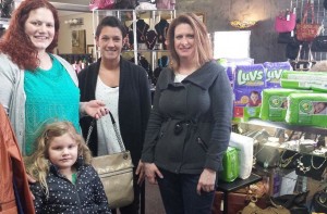 From left are Andrea Compson, winner of a Coach purse; Amy Pixton, B.A.B.E. Program Coordinator; Melissa Ryan, owner The Boutique Exchange. (Photo provided)