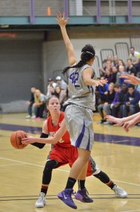 Taylor Goshert makes a pass around a Goshen College defender in a game played last month. Goshert is the vocal leader and senior captain of an Indiana Wesleyan team hoping to win its second consecutive national title at next week's NAIA Women's Division II National Tournament. (Photo by Nick Goralczyk)