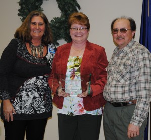 North Webster Chamber of Commerce Preident Sue Ward, left, presented Judy and Ed Clayton, Clayton's Garden Center, the Large Business of the Year award. (Photo by Martha Stoelting)