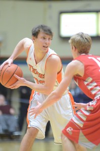 Tim Swanson protects the basketball for Warsaw versus Goshen.