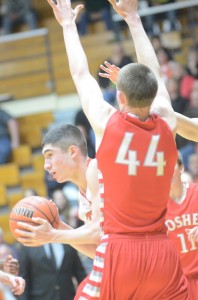 Jake Mangas finds his path blocked by Goshen's Austin Woolett at North Side Gym Tuesday night.