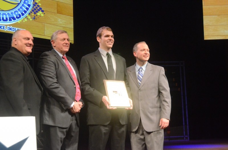 Greg Miller proudly displays his Pete Maravich Award Tuesday night. Shown with the Grace College star are (from left) Men's d-1 NCCAA National Chair Jeff Santarsiero, Grace College men's basketball coach Jim Kessler and Grace College Director of Athletics Chad Briscoe.