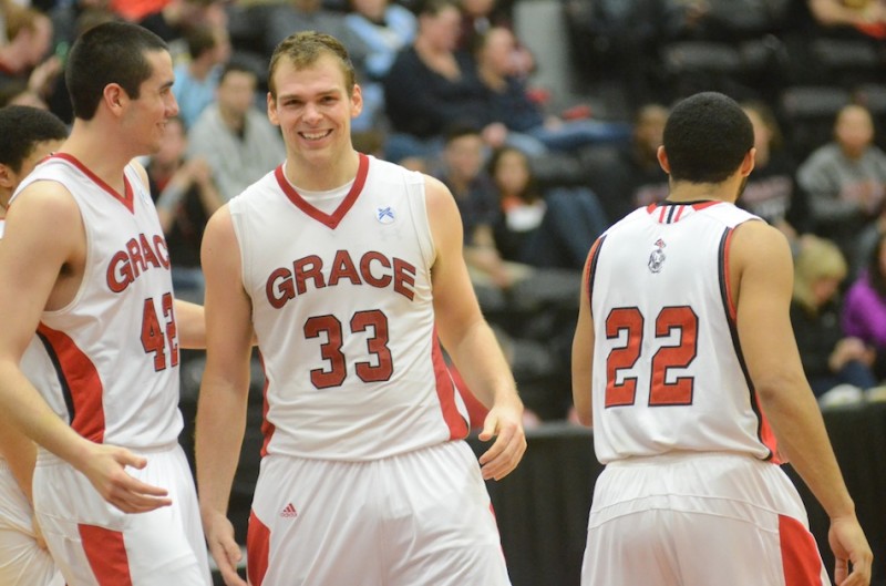 Greg Miller (33) celebrates with teammate Jared Treadway after a basket Wednesday night. Miller scored a game-high 24 points to power the Lancers past Colorado Christian 81-71 in a first-round game of the NCCAA Championships at Grace.