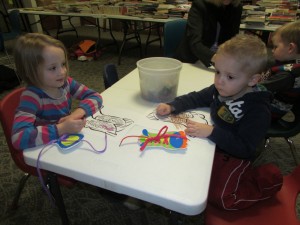 Shelby Miller and Charlie Miller practice tying shoes and color a pair of dancing shoes during Winter Story Time, Winter Waltz (Photo provided)