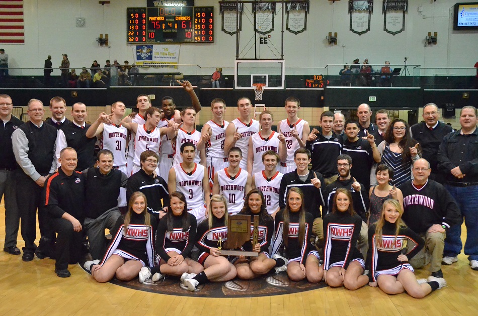 The NorthWood boys basketball program poses after winning the Wawasee Boys Basketball Sectional Saturday night. The victory marked the fifth time NorthWood has won a boys basketball sectional title. (Photos by Nick Goralczyk)