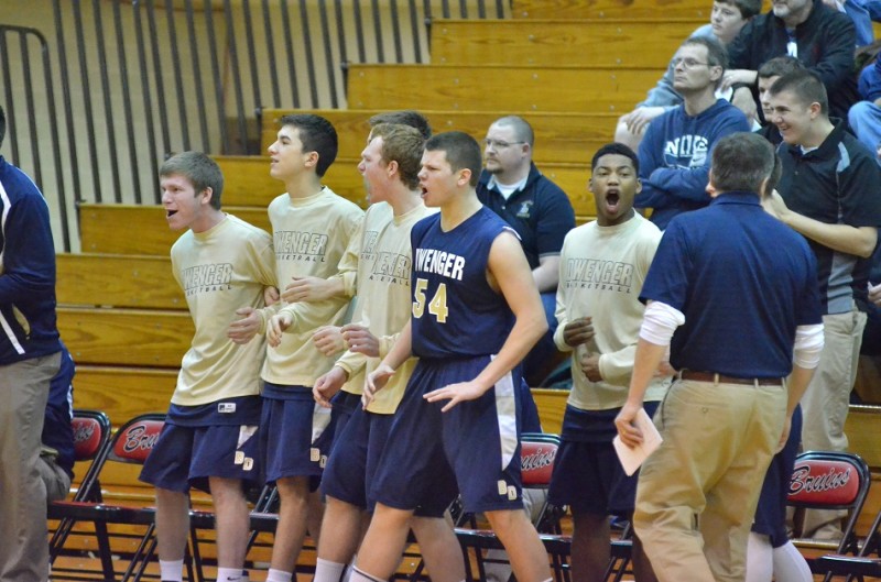The Dwenger bench erupts after a charge is called on NorthWood's Zach Zurcher. (Photos by Nick Goralczyk)