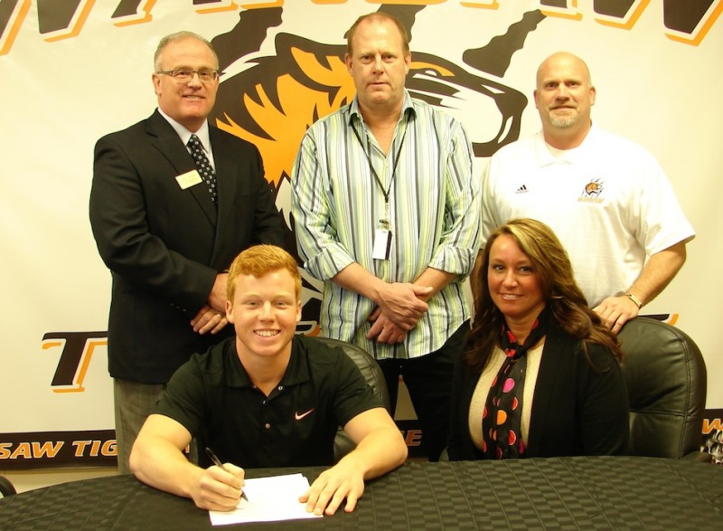 WCHS senior Tanner Balazs has signed to play football at Wabash College. In front are Balazs and Beth Chaplin. In back are WCHS principal Troy Akers, WCHS football coach Phil Jensen and WCHS athletic director Dave Anson (Photo provided)