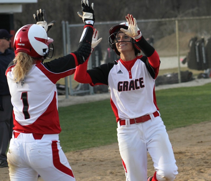 Alex Shipley is congratulated by Brooke Shell earlier this season. The pair helped Grace to two wins at Marian Tuesday (File photo provided by Grace College Sports Information Department)