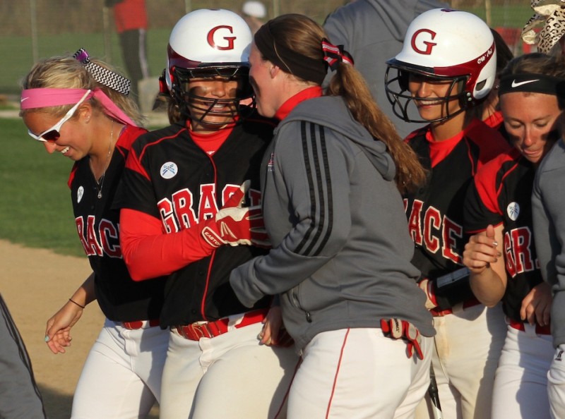 Senior Olivia Winget is congratulated after hitting a home run for Grace Saturday. Winget hit two on the day as the host Lancers won a pair (Photo provided by Grace College Sports Information Department)