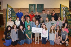 Kelsey Turner, freshman, was presented a check made out to Make-A-Wish by the Warrior Leadership Committee. Shown are some of the committee members (some were not available when the photo was taken). Kneeling, in front from left, are Tiarra Culp, Grace Crays, Amanda Bradley, Samantha Malik, Turner (standing and holding the check), Alex Fiscus, Leeann Estrada, Jada Antonides and Cole VanLue. In the middle row are Chelsea Carolus, Carly Erst, Sarah Harden, Ashley Beer, Megan Goralczyk, Jerrica Bontrager, Molly Swartz, Shelby Swartz, Lydia Katsaropoulos and Katie Ashpole. In the back row are Kody Carpenter, Michael Pena, Ron Vardaman, Jordan Brown, Brandon Fox, Colfax Cannaday and Caleb Dingeldein.