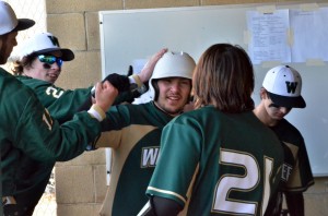 Nate Hare is congratulated by his teammates after scoring one of the Warriors 18 runs.