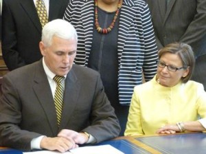 Gov. Mike Pence signs Rep. Rebecca Kubacki's victims of domestic violence bill into law. (Photo provided)