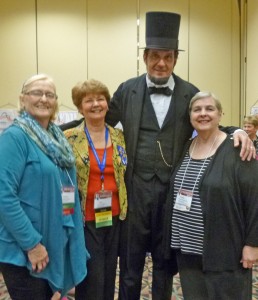 From left are Altrusa International of Warsaw club members Martie Lennane, Sue Creighton and Susan Woodward celebrating with “President Abe” after their club won Altrusa's District Six Mamie L. Bass Service Award for service.  The club members were attending the annual Altrusa International District Six Conference in Springfield, Ill., where the winner of the award was announced during the Awards Luncheon on May 3. (Photo provided)