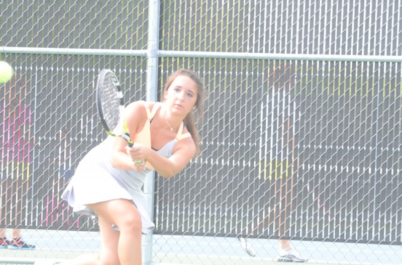 Jacqueline Sasso makes a backhand return Thursday for Warsaw in No. 1 singles play in sectional action.