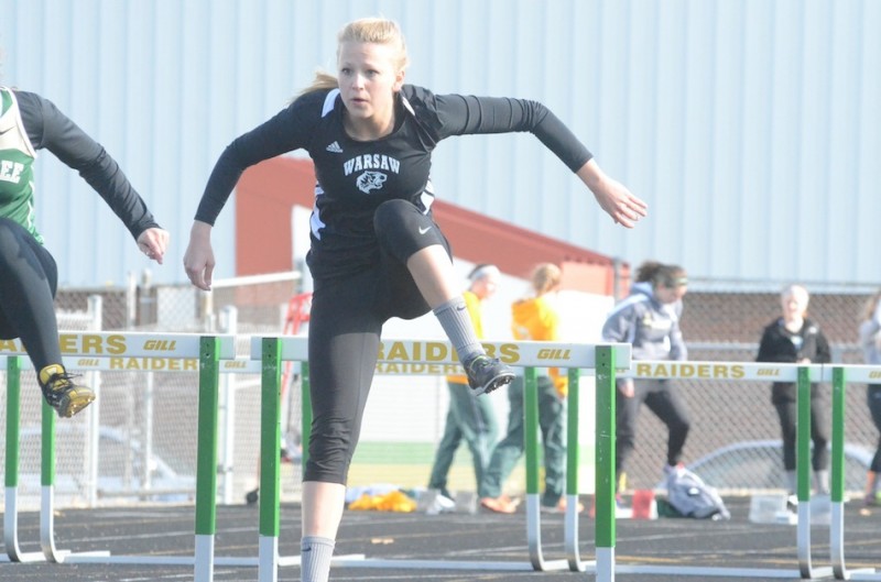 Warsaw's Claire Hickerson competes in the 100 hurdles earlier this season. She was fourth in the event Saturday in a personal-best time to help her team take second place at the Kokomo Relays.