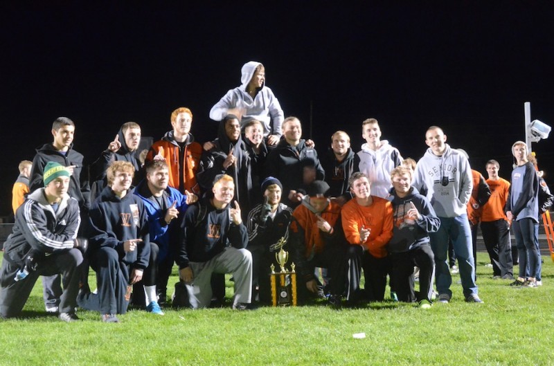 The senior members of the Warsaw boys track team celebrate Friday night after winning their own Max Truex Invitational.