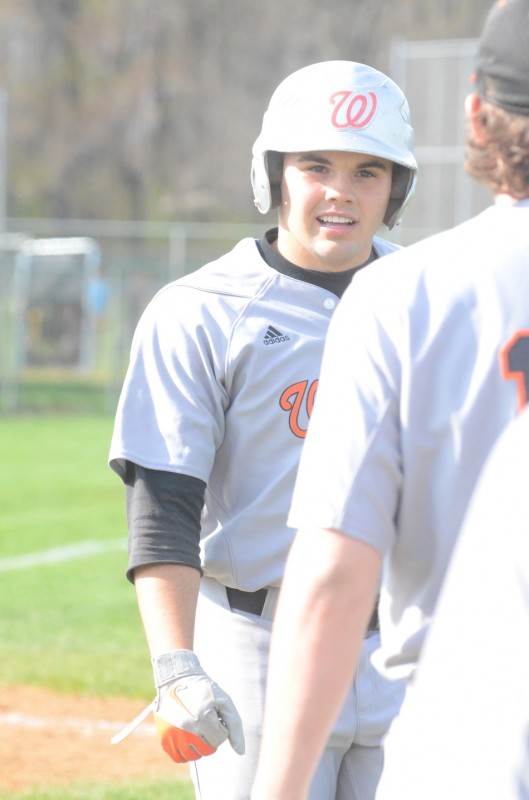 Ethyn Bradley heads to the dugout after scoring a run for Warsaw Monday.