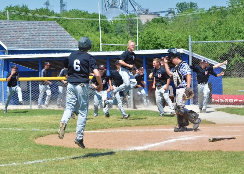 The NorthWood dugout erupts after Dominic Miranda crushes a grand slam in the top of the seventh inning to give the Panthers a 9-5 lead. (Photos by Nick Goralczyk)