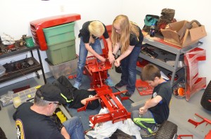 Students work on assembling the tractor they will sell to a bidder in June.  (Photo by Alyssa Richardson)
