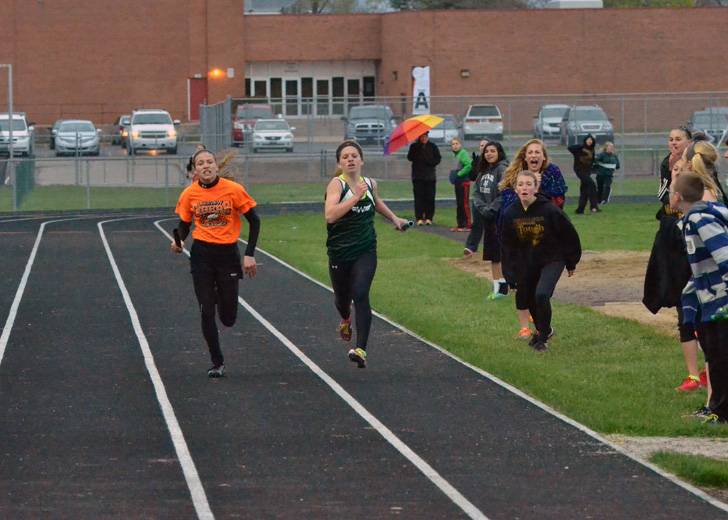 Abbie Curtis (left) and Aubrey Kuhn (right) race neck and neck in the final stretch of the 4x400 relay. Kuhn would edge out Curtis to win the race and the Lakeview Relays title. (Photos by Nick Goralczyk)