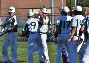 Drew Wright (27) is congratulated by teammates after scoring the tying run in Friday's ball game. (Photos by Nick Goralczyk)