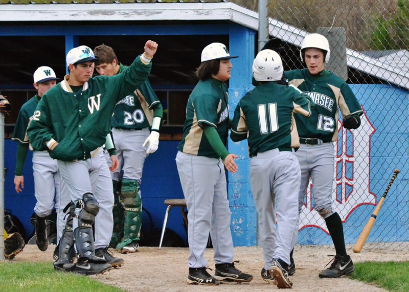 The Warrior dugout comes out to greet Andrew Milligan (11) after he gave Wawasee a 2-1 lead in Wawasee's 14-3 win over Whitko. (Photos by Nick Goralczyk)