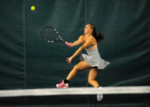 Abbi Baum of Warsaw's two doubles team leaps to return a shot against Plymouth during the opening round of the Northern Lakes Conference Girls Tennis Championships.