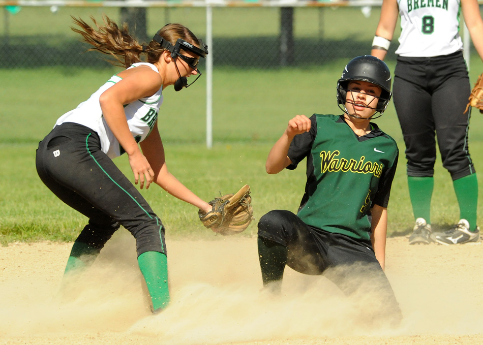 Wawasee's Cristina DeLaFuente slides in under the tag attempt of Bremen's Brooke Fitch after doubling in the first inning Friday night. Bremen would win the game 6-3. (Photos by Mike Deak)