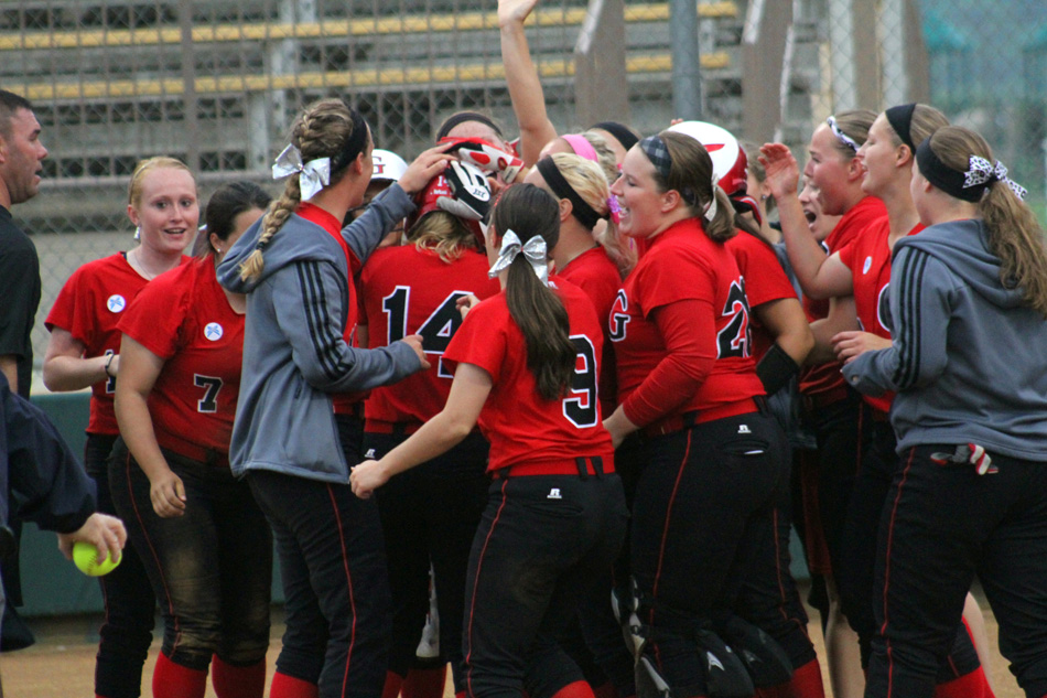 Grace College's softball team celebrates a solo home run by Brittany Melzoni Thursday during the NCCAA tournament game against Trinity Christian. Grace won the game 12-3. (Photo provided by the Grace College Sports Information Department)