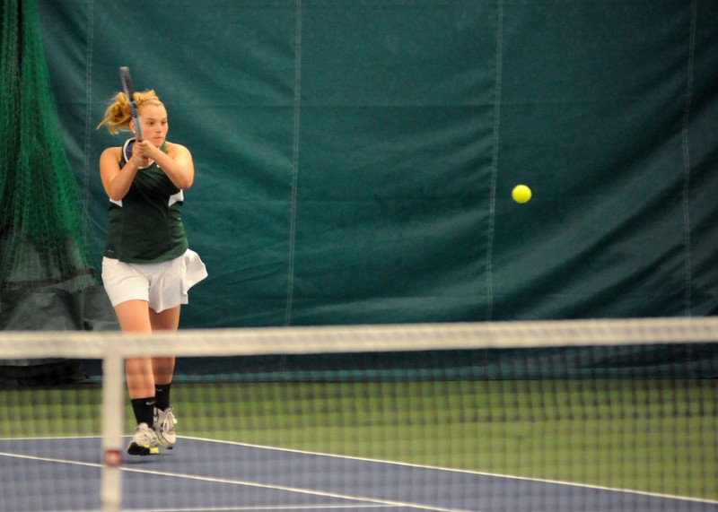 Wawasee sophomore Erin Wiktorowski hits a shot in No. 1 doubles play during the opening round of the NLC Tournament Wednesday night. The tourney continued indoors Thursday night (Photos by Mike Deak)