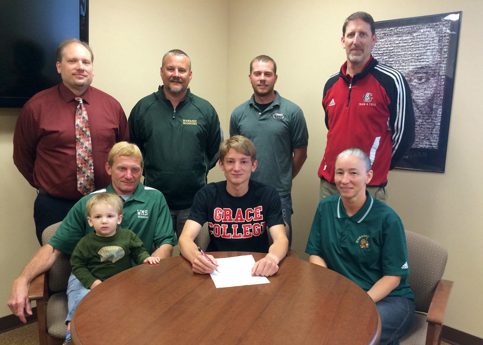 Wawasee senior Austin Yoder has chosen to continue his running career with Grace College. Pictured at the signing are, in front from left, father Gene Yoder, brother Easton Yoder, Austin Yoder, and mother Loretta Yoder. In the back row are WHS principal Mike Schmidt, Wawasee track coach Scott Lancaster, Wawasee cross country coach Doug Slabaugh and Grace College track and field coach Jeff Raymond. (Photo by Mike Deak)