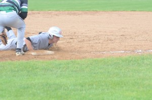 Sterlin Hay dives back into first base on a pickoff attempt.