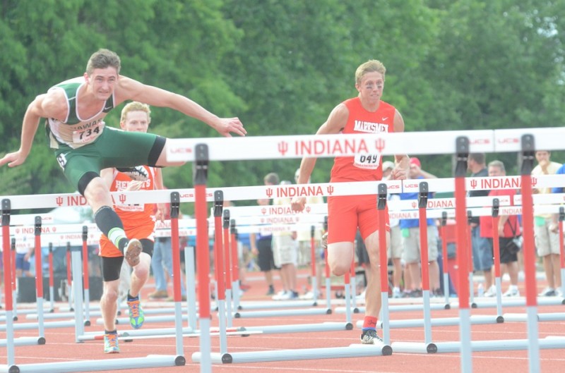 Wawasee's Clayton Cook competes in the 110 hurdles at the State Finals in Bloomington Saturday night. The junior star earned a fifth-place finish in the event.