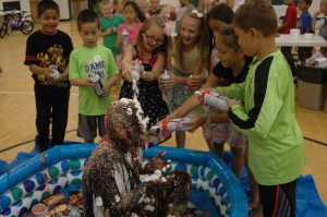 Milford Elementary students had an opportunity to turn physical education teacher Brent Berkeypile into a human ice cream sundae during the annual awards ceremony last week. Pictured garnishing Berkeypile with toppings are students (from left) Junior Nunez, Christopher Estrada, Rylie Penrod, Britney Kidd, Ciara Rodriquez, Josie Melton and Kyser Bordones.