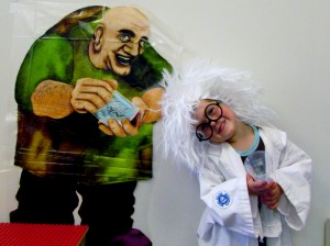David Owens poses as a mad scientist in the children’s department after reading 35 hours for the summer reading program.