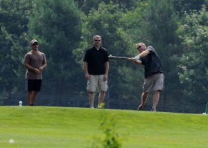 Andy Kryder takes a swing with the baseball bat on the third hole during action at Goofy Golf Saturday morning at Wawasee Golf Club. (Photos by Mike Deak)