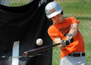 Warsaw's Bryce Sensibaugh takes a cut in the cage in preparation for the State Tournament.
