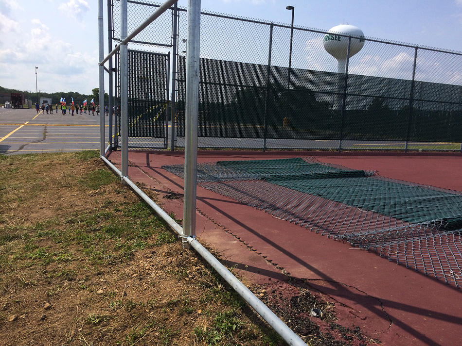 Work is still being completed on the tennis complex fencing after early July's storms ripped down the borders of the cages. Construction is ongoing despite programs beginning fall practice. (Photos by Mike Deak)