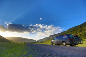 The van, which acted as a support system for the Tour Divide riders, and a working home environment for the Geigers can be seen here driving off into the sunrise. (Photo by the Geigers)