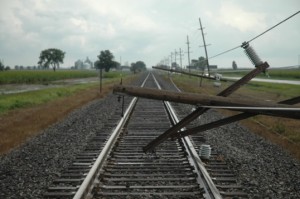 Two downed utility poles block the railroad tracks about a mile south of Milford Tuesday afternoon. The poles were felled by straight line winds about 3:30 p.m. and train traffic was restored around 6:15 p.m.