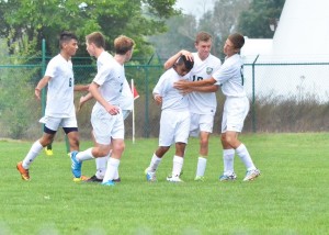 Carlos Camargo (center) is congratulated by his teammates after evening up the score 2-2 against Concord.