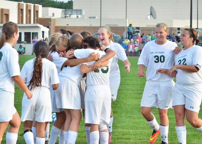 The Lady Warriors celebrate after earning their first victory since 2012. (Photos by Nick Goralczyk)