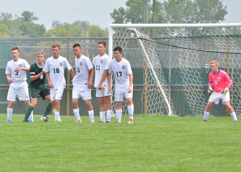 Wawasee prepares to defend a Concord free kick while Jared Long (#8, green) tries to slip through the Warrior defense.