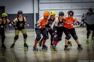 Members of the Bone City Rollers block a jammer during the February bout with Dire Skates of Richmond. (Photo by David Davison)