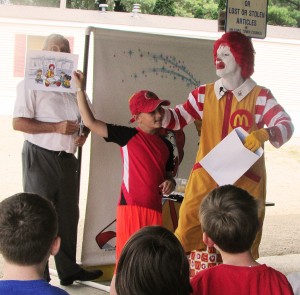 Devin VanLue participates in a game showing Ronald McDonald reading at the Grand Finale Picnic on July 31. (Photo provided) 