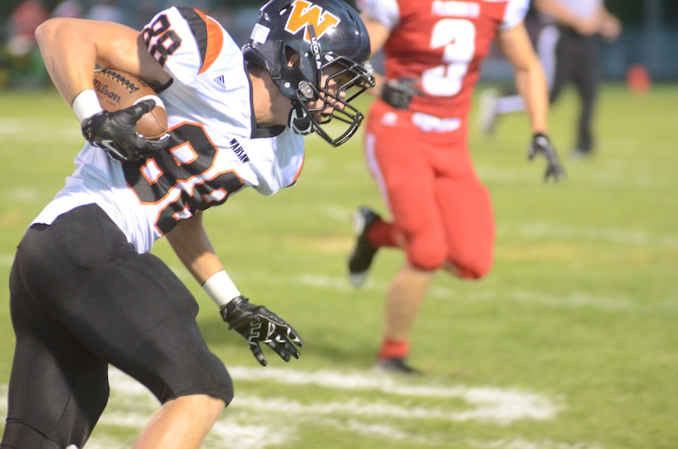 Warsaw receiver Thomas Hickerson heads upfield versus Plymouth.