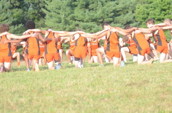 The Warsaw boys cross country team huddles up prior to the start Tuesday.