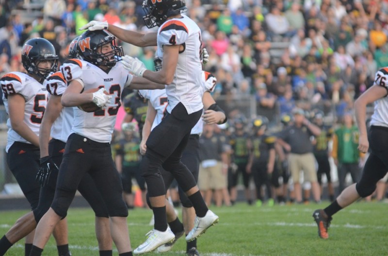 Riley Rhoades congratulates Brock Riley on a touchdown catch Friday night for the Tigers.