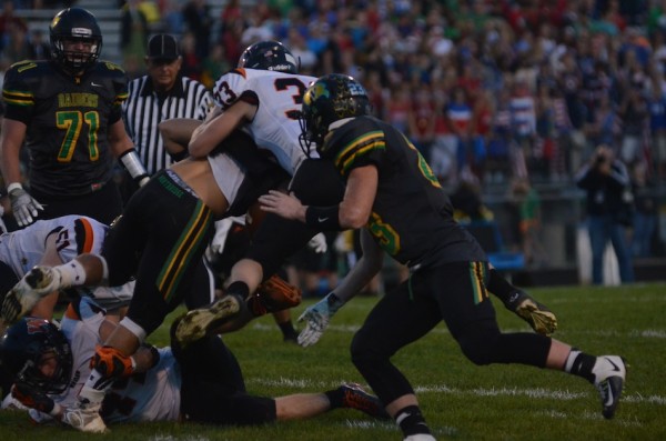 Warsaw's Ross Armey puts a hit on a Northridge back last week. The Tigers host Goshen Friday night.